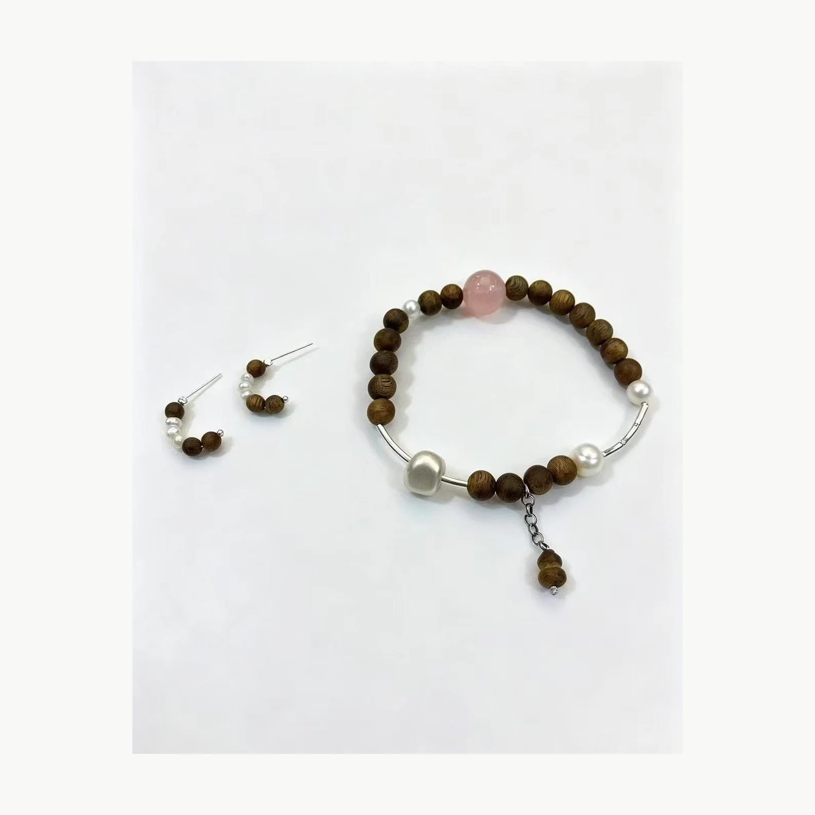 Agarwood rose quartz pearl bracelet and earring set front view