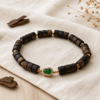 Kynam agarwood jade barrel bead bracelet side detail showing wood grain