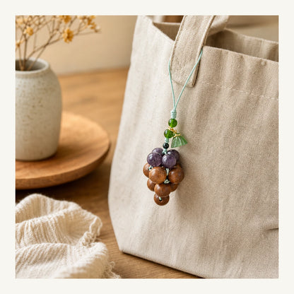 Lavender Osmanthus Grape Incense Bag Charm styled on a linen bag