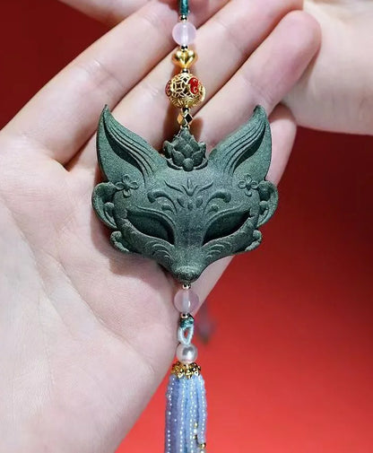 Detail view of the carved fox aromatic scent pendant
