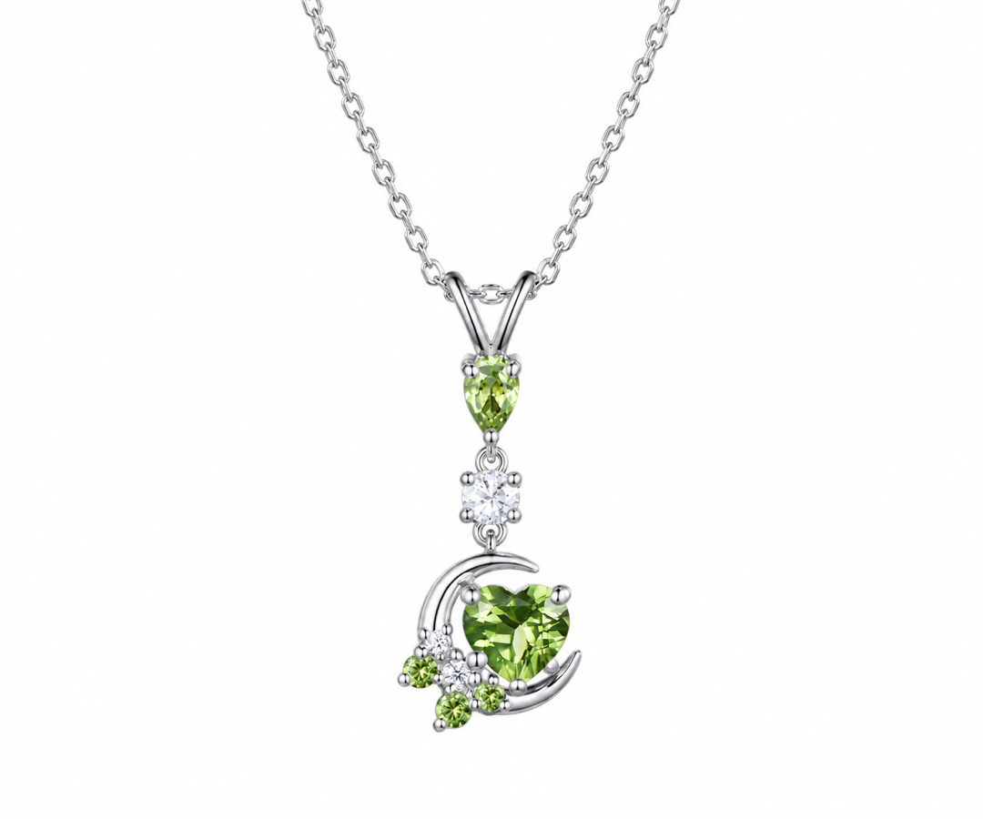 Sterling silver moon and stars necklace with a heart-cut green peridot